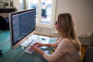 Remote workers works from home office logged into Fingercheck to record worked hours.