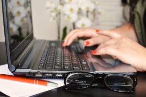 Hands typing on keyboard.