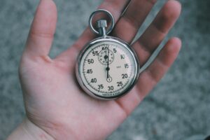 Rusted pocket watch held in hand signifying outdated time tracking practices to stop holding onto.