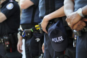 Detroit police officers somberly lined up in full uniform, expressing opposition to new time clock system.