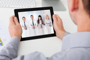Job applicant confidently video interviews on a tablet using Fingercheck's tips as a guide.