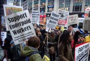 Herald Square, Manhattan, 24th October 2013 protest with signs of support underpaid New Yorkers, signifying state-wide sentiment for need for social and financial reform leading up to the new budget accomplishments.