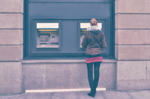 Employee withdraws cash using her ATM paycard.