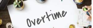 Professionals with coffee sit around table with large Overtime sign in the middle, brainstorming strategies for keeping costs stable with the new changes.
