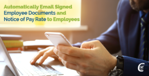 Businessman's hands up close, typing while looking at phone checking that the signed forms and NYS notice of pay rate have been sent through Fingercheck Payroll.