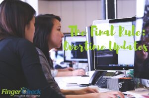 Two young women in office both looking at the same computer screen getting an update on the status of the new overtime rule from Fingercheck's blog.