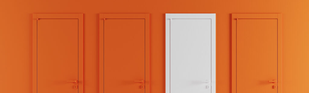 One white door stands out against three orange doors representing a stand-out candidate during the hiring process who has options to consider.
