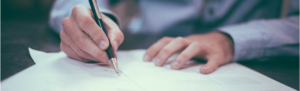 Independent contractor signing a contract deal confirming his hire agreement and worker classification.