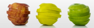 Three brightly colored apples sliced and spinning against white background to represent superfoods that are nutritious and help bosses and employees be at their most productive.