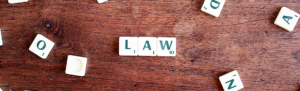 Scrabble tired spell "Law" in reference to jury duty pay requirements employers need to know.