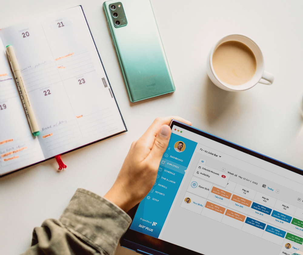 person holding a laptop with FIngercheck scheduling app on the screen