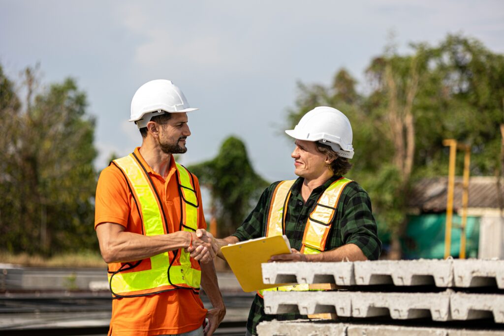 Construction contract workers discussing certified payroll compliance