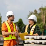 Construction contract workers discussing certified payroll compliance