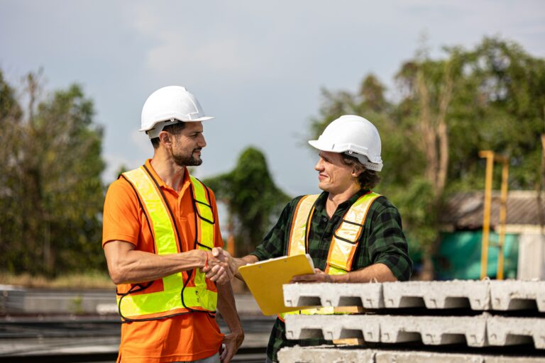 Construction contract workers discussing certified payroll compliance