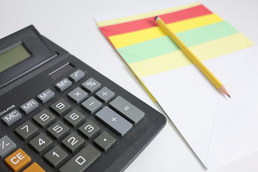 Calculator next to a sheet of paper for a small business calculating federal withholding taxes.